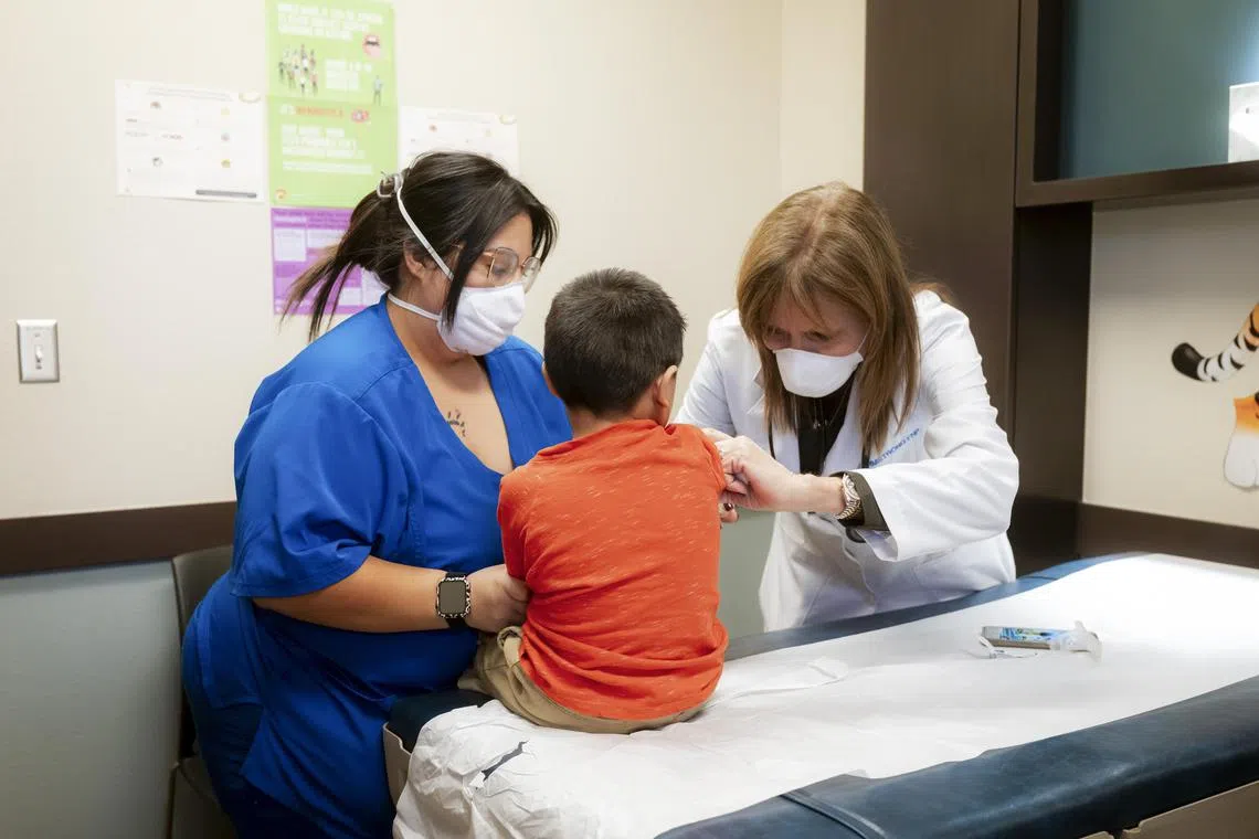 Nurses administer a measles vaccine at a hospital in Seminole, Texas.