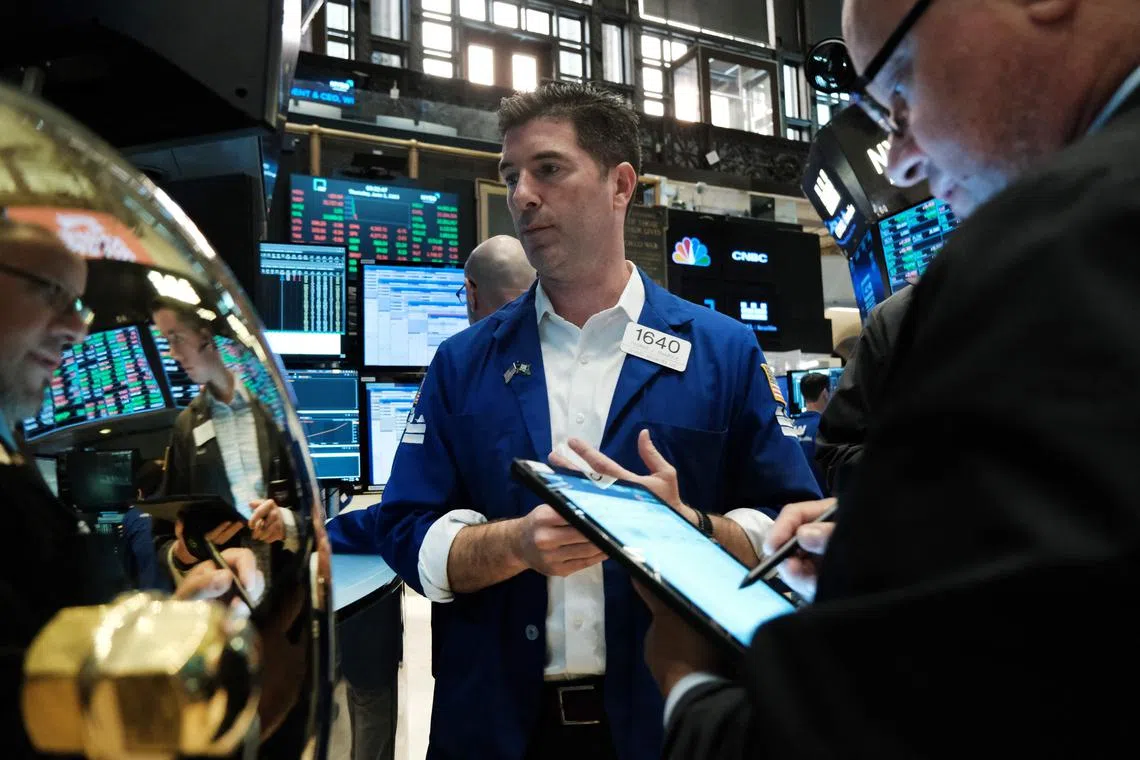 Traders work on the floor of the New York Stock Exchange, in New York City.