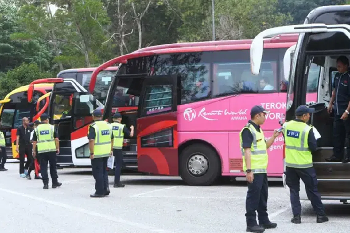 Malaysia's enforcement officers inspecting tour buses and vans in Gombak, Selangor, on July 2. 