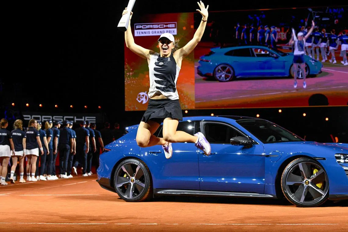 Poland's Iga Swiatek jumping in the air as she celebrates with the trophy after her 6-3, 6-4 Stuttgart Open final win over Belarus' Aryna Sabalenka on Sunday.