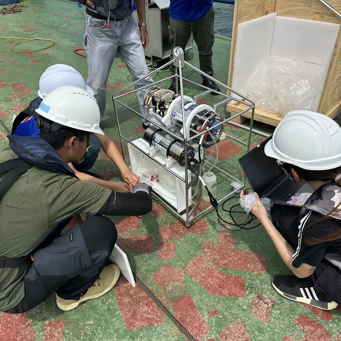 NUS researchers testing out a special system of “traps within a trap” for the expedition.