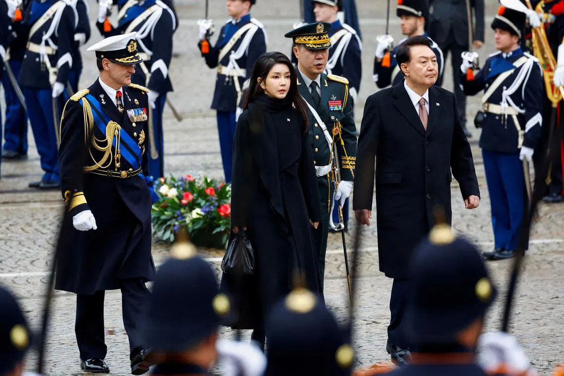 South Korea's President Yoon Suk Yeol (right) and his wife Kim Keon Hee walk during a ceremony in Amsterdam, Netherlands on Dec 12, 2023.