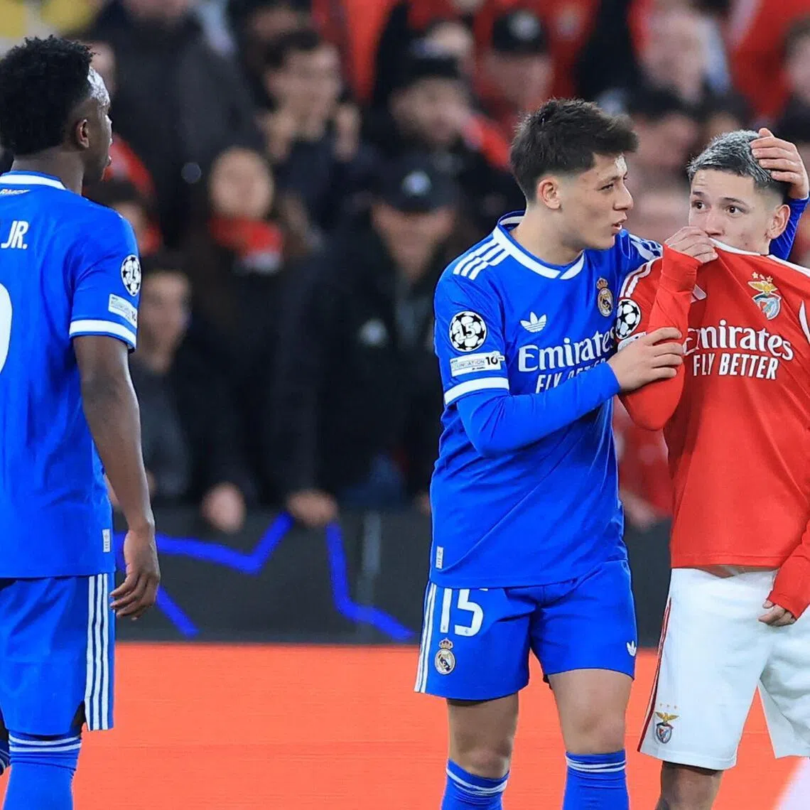 Benfica's Argentinian winger Gianluca Prestianni hiding his mouth while arguing with Real Madrid's Brazilian forward Vinicius Jr, who complained about alleged racists insults during the Champions League knockout round play-off, first-leg football match at the Estadio da Luz in Lisbon on Feb 17, 2026. 