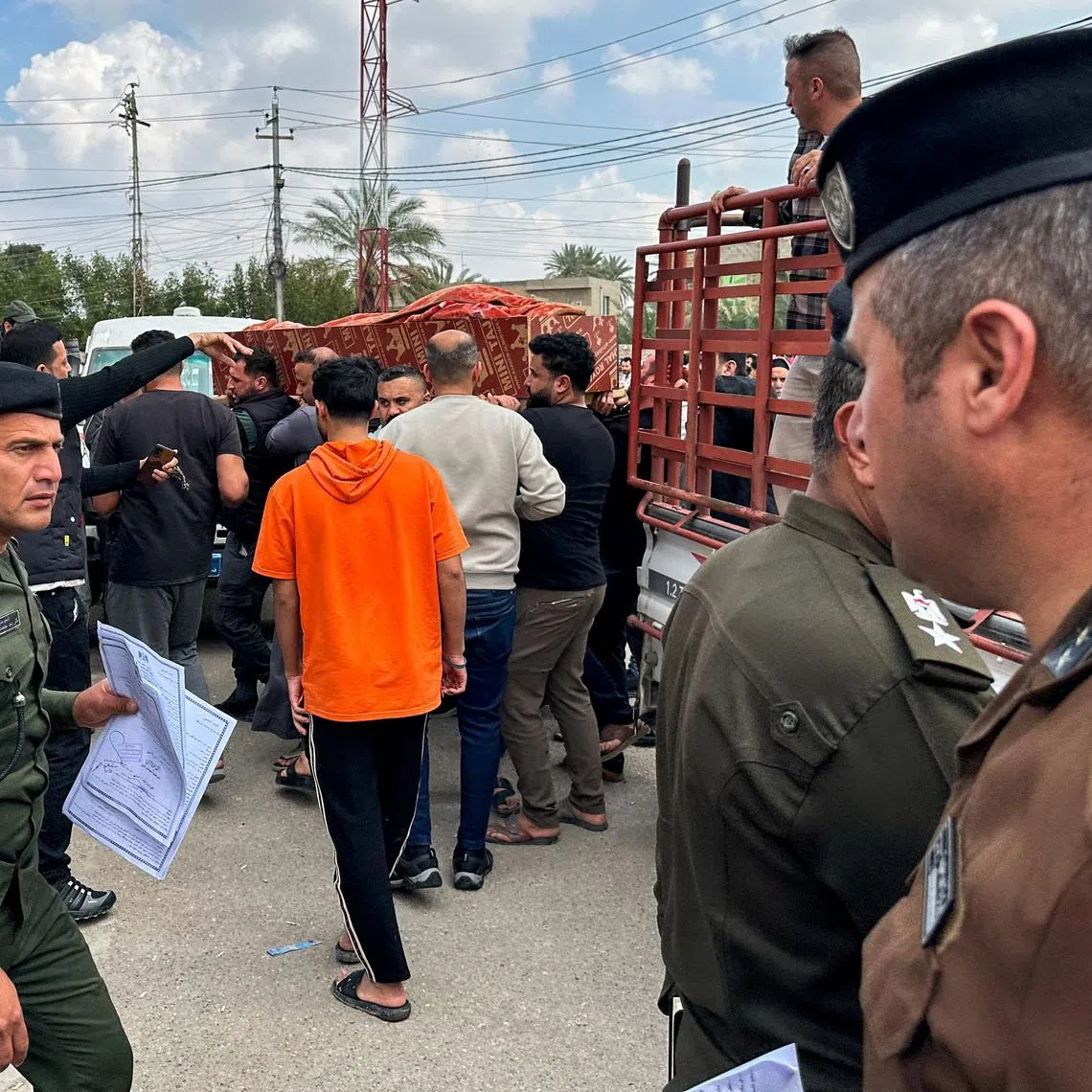 Relatives carry the coffin of an Iraqi soldier killed in an airstrike near an army medical centre in western Anbar, at the forensic medicine department of Ramadi General Hospital, Iraq March 25, 2026. REUTERS/Osama Al-Dulaimi
