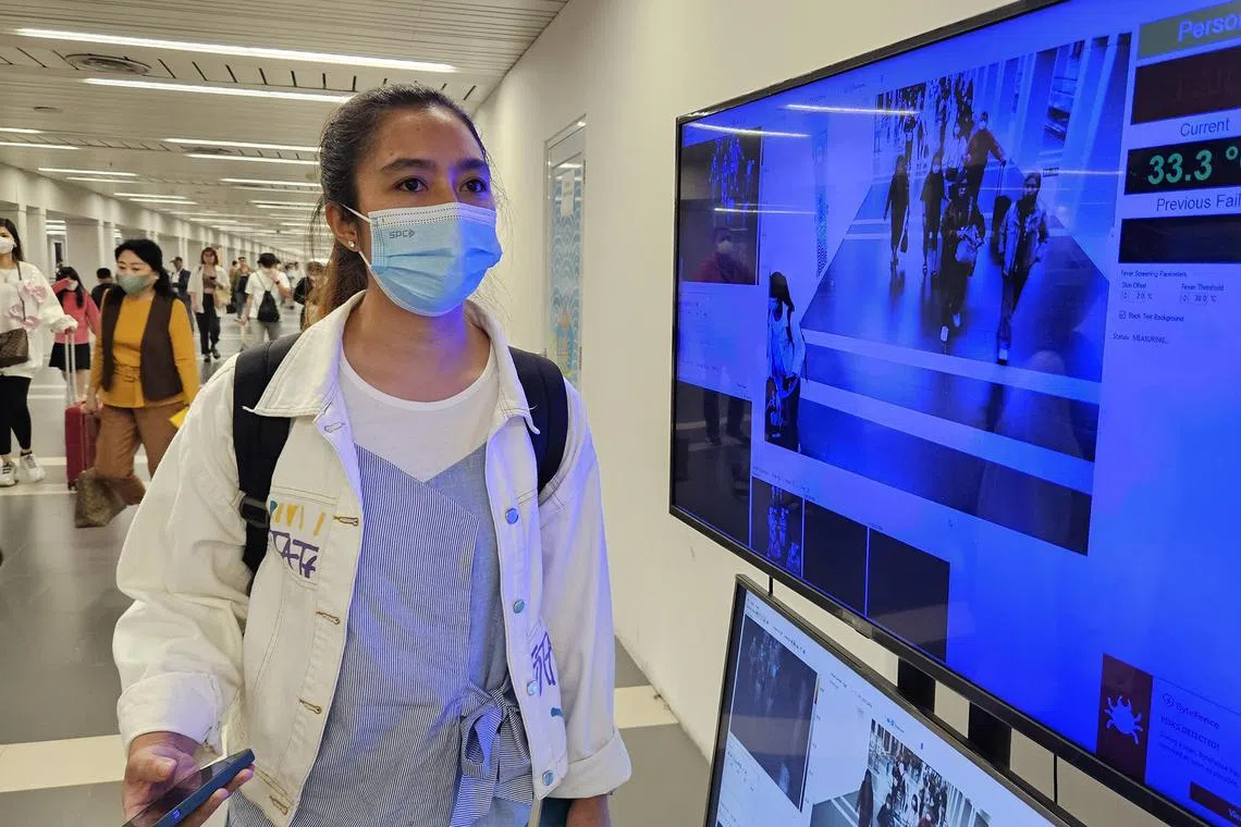 aacovid12 - Indonesian Perdana Handayani, 33, project administrator, walks past a thermal scanner at Soekarno Hatta international airport. Indonesia has tightened border control with recent spike in Covid-19 cases in Singapore.


Photo: Arlina Arshad