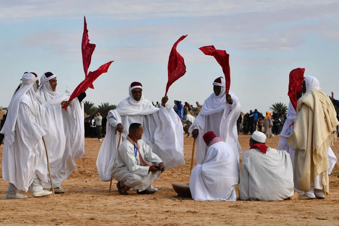 Performers wearing traditional outfits taking part in a show at the start of the International Sahara Festival on Dec 27, 2023 in Douz, in southern Tunisia. 