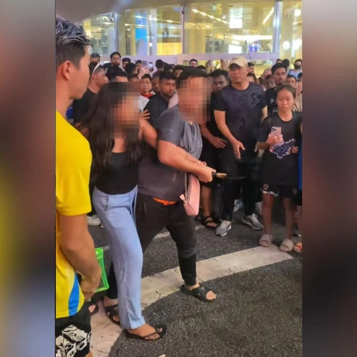 In a viral video, a man can be seen attempting to disarm the woman.