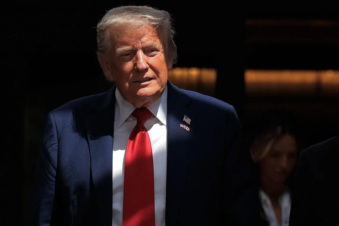 US President Donald Trump walks out to talk to reporters after signing a trade agreement with British Prime Minister Keir Starmer during the G7 Leaders' Summit on June 16. 