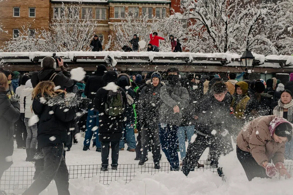 People engage in a snowball fight after a snowstorm at Washington Square Park in New York on Feb 23.