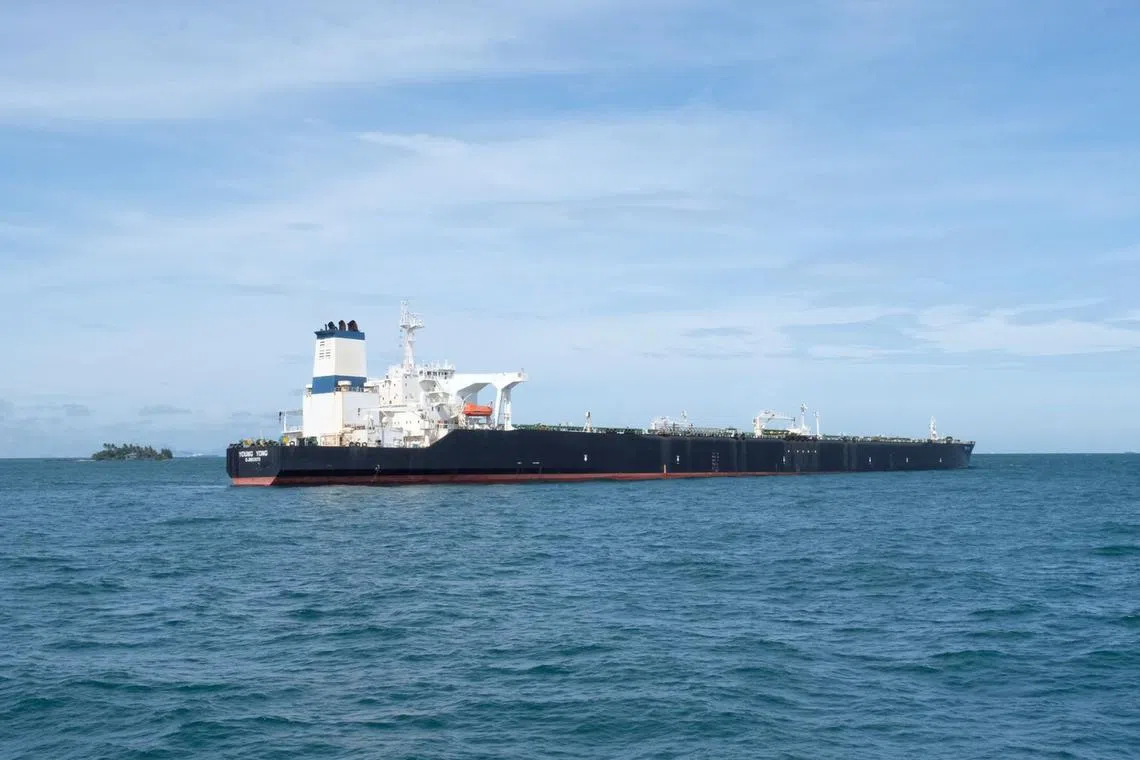 Indonesian authorities are attempting to pump out the oil from a supertanker that ran aground in Indonesian waters just off Singapore