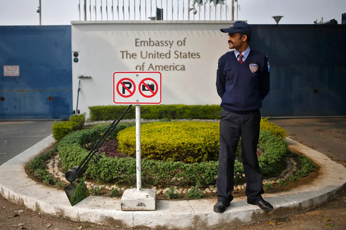 FILE PHOTO: A private security guard stands outside the U.S. embassy in New Delhi December 18, 2013. REUTERS/Anindito Mukherjee/File Photo