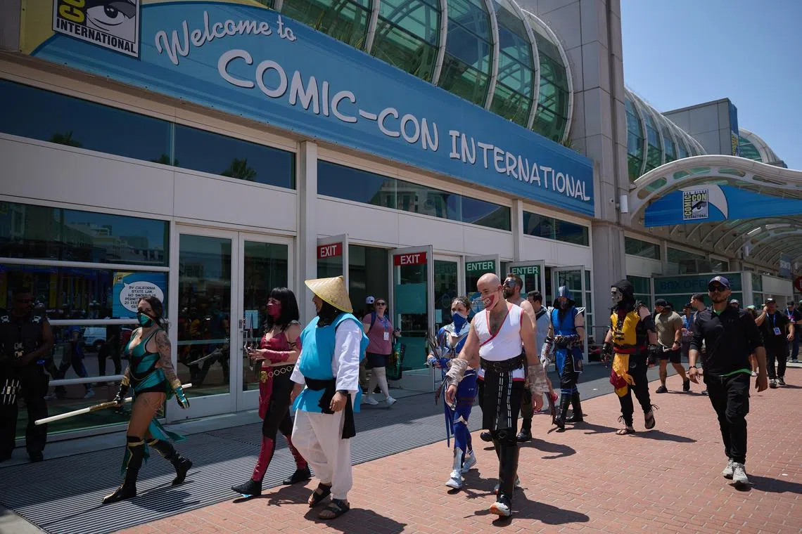 People in cosplay walk by the entrance to Comic-Con International in San Diego on July 26. San Diego Comic-Con is one of the world’s largest pop culture events. 
