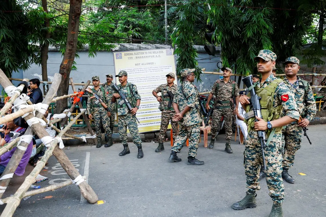 Security personnel stand guard during vote counting for the West Bengal legislative assembly election polls outside a counting centre in Kolkata, India, May 4, 2026.