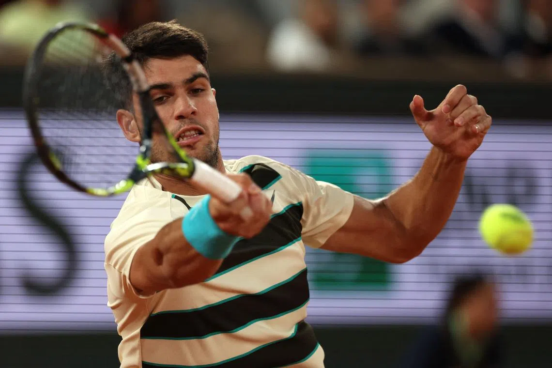 Carlos Alcaraz plays a forehand return to Tommy Paul during their quarter-final men's singles match on day 10 of the French Open.