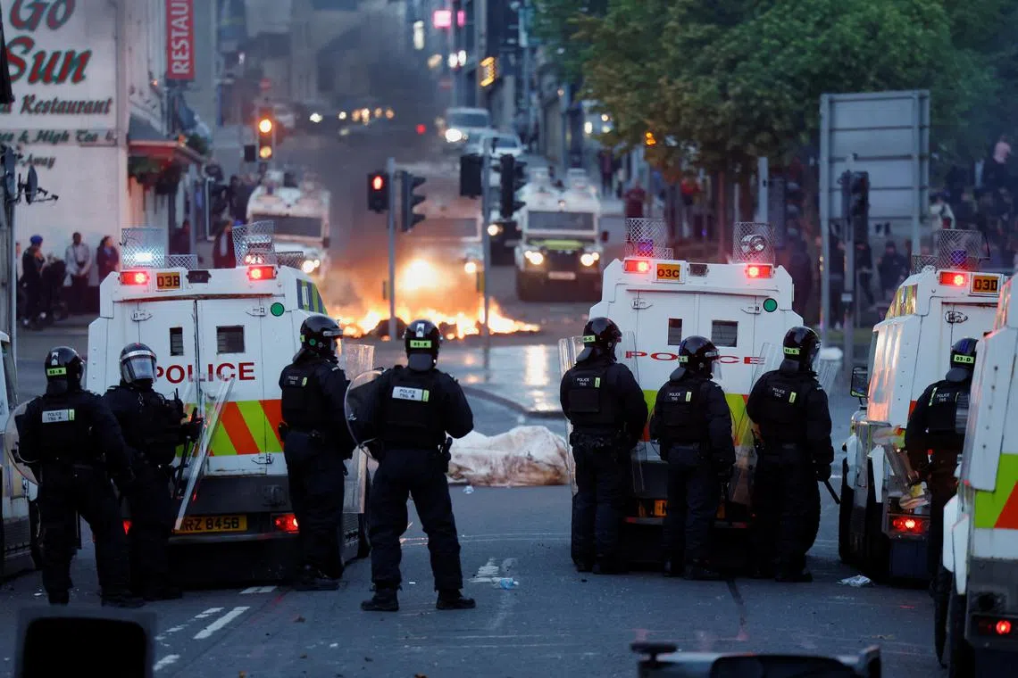 Armed police in riot gear stand guard during a second night of riots, in Ballymena, Northern Ireland, June 10, 2025. REUTERS/Clodagh Kilcoyne