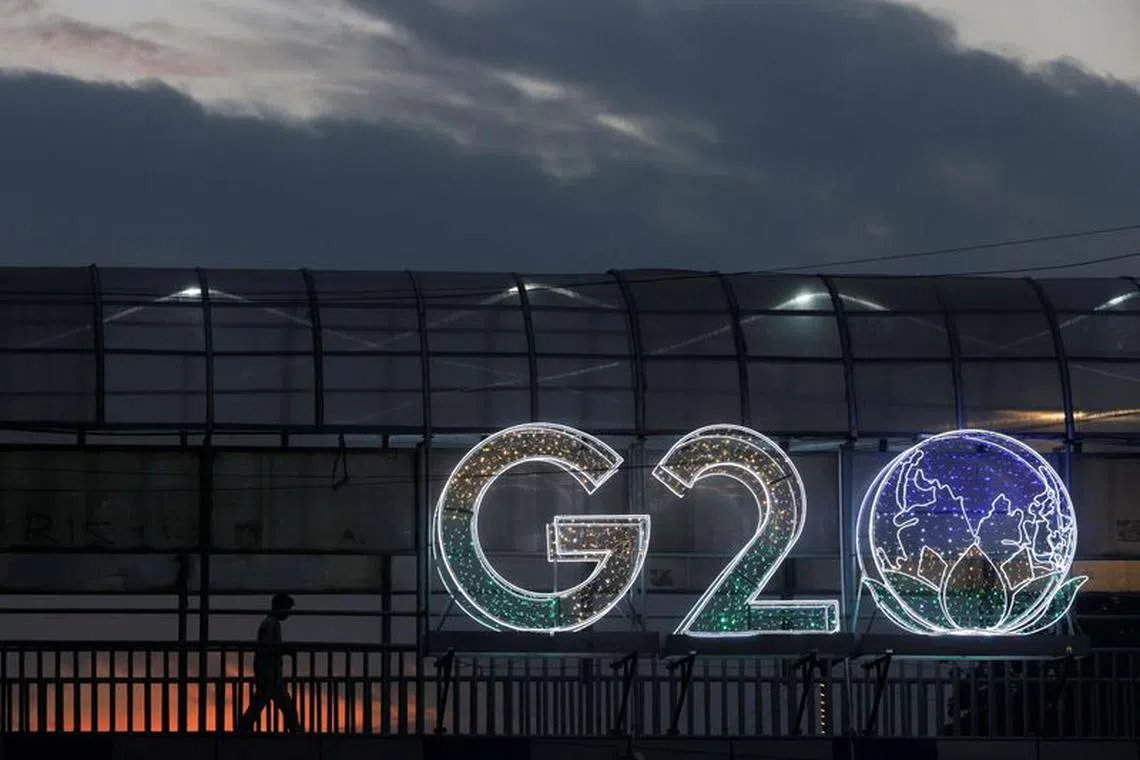 A man walks past an installation on a skywalk ahead of the G20 Summit in New Delhi, India, September 6, 2023. REUTERS/Francis Mascarenhas/File photo