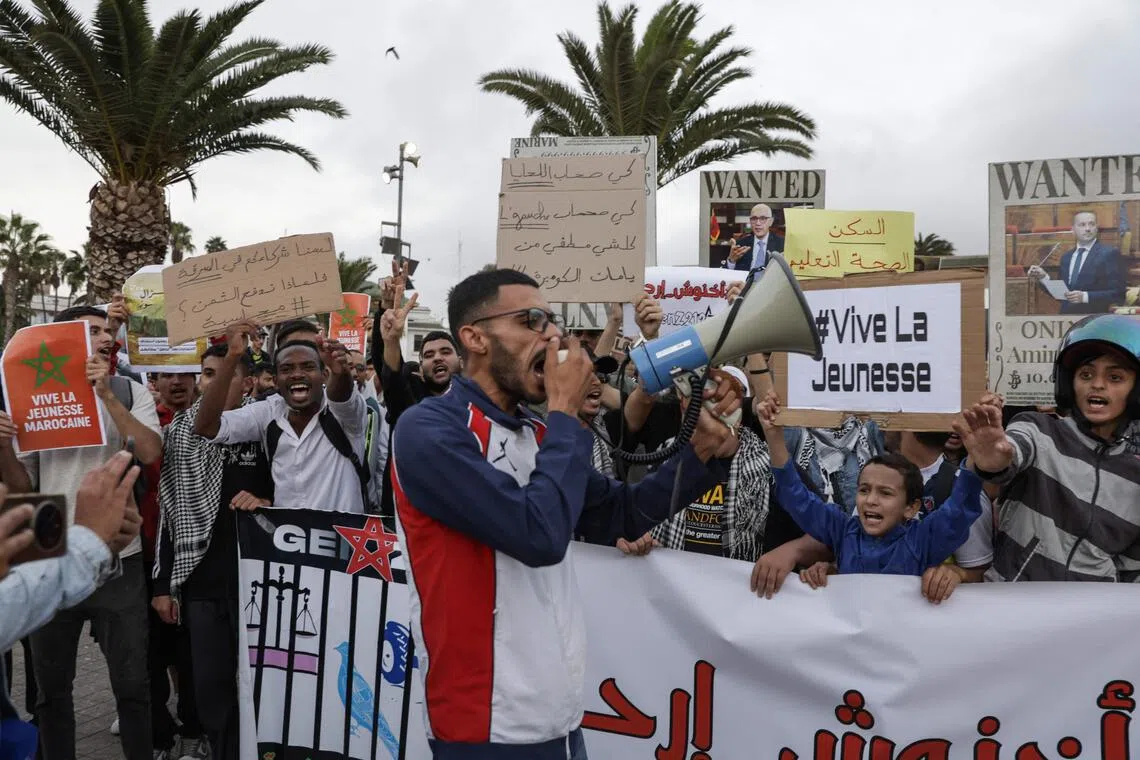 Demonstrators lift placards and chant slogans during a youth-led protest demanding reforms to public healthcare and education at Mohamed V square in Casablanca on October 6, 2025.