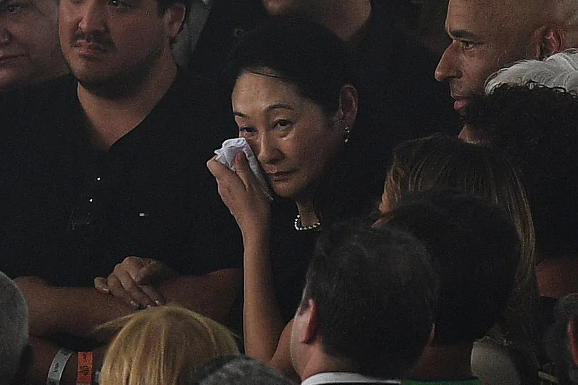 The wife of late Brazilian football legend Pele, Marcia Aoki, cries during his wake at the Urbano Caldeira stadium in Santos, Sao Paulo, Brazil on Jan 3, 2023. 