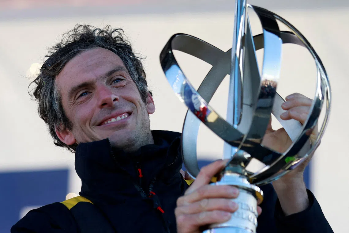 FILE PHOTO: Sailing - Arrival of the Vendee Globe winner - Les Sables-d'Olonne, France - January 14, 2025 Macif Sante Prevoyance's Charlie Dalin holds the trophy onstage as he arrives in port after winning the Vendee Globe REUTERS/Stephane Mahe/File Photo