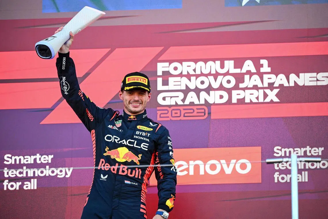 Red Bull's Max Verstappen celebrates on the podium after winning the Japanese Grand Prix.