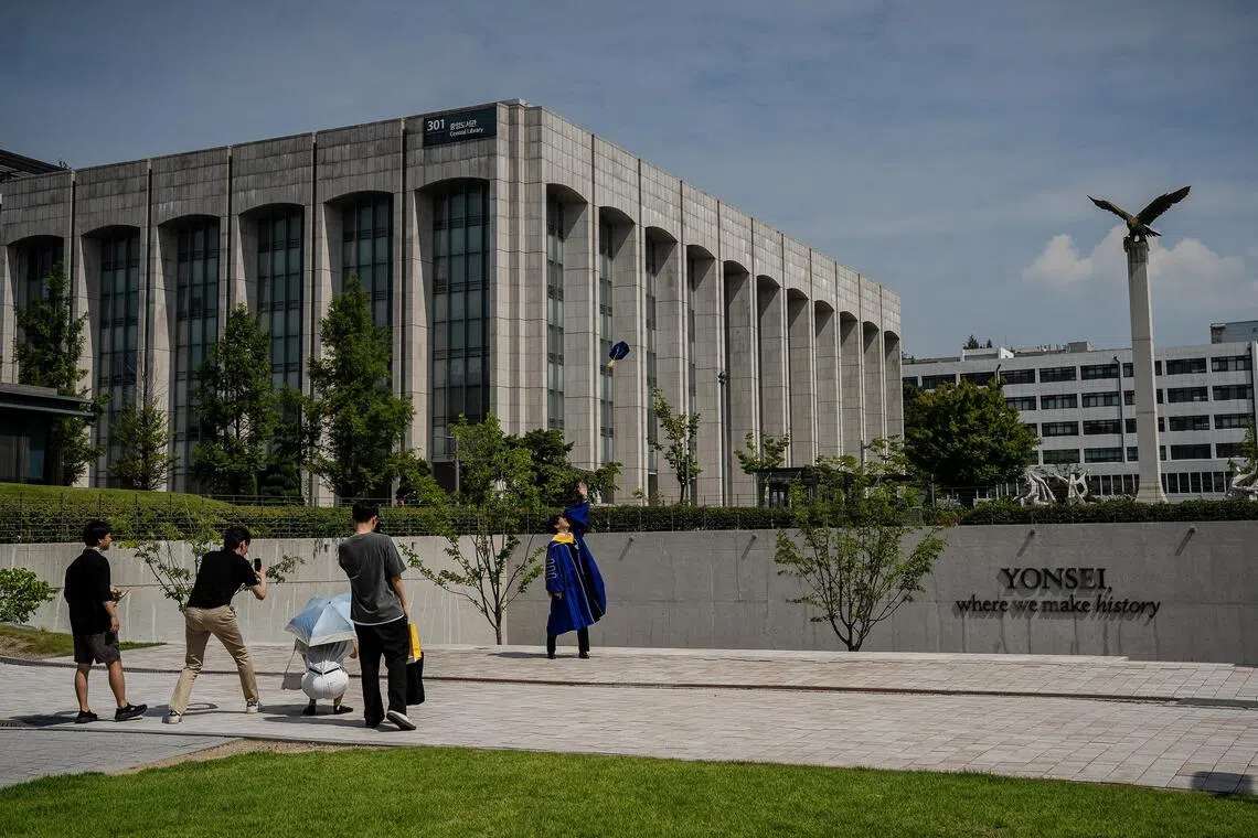 A graduate tosses his cap at Yonsei University in Seoul, on Saturday, Aug. 1, 2025. South KoreaÕs elite universities have been left scrambling after it emerged that testing season was marred by a spate of mass cheating incidents involving AI. (Tina Hsu/The New York Times)