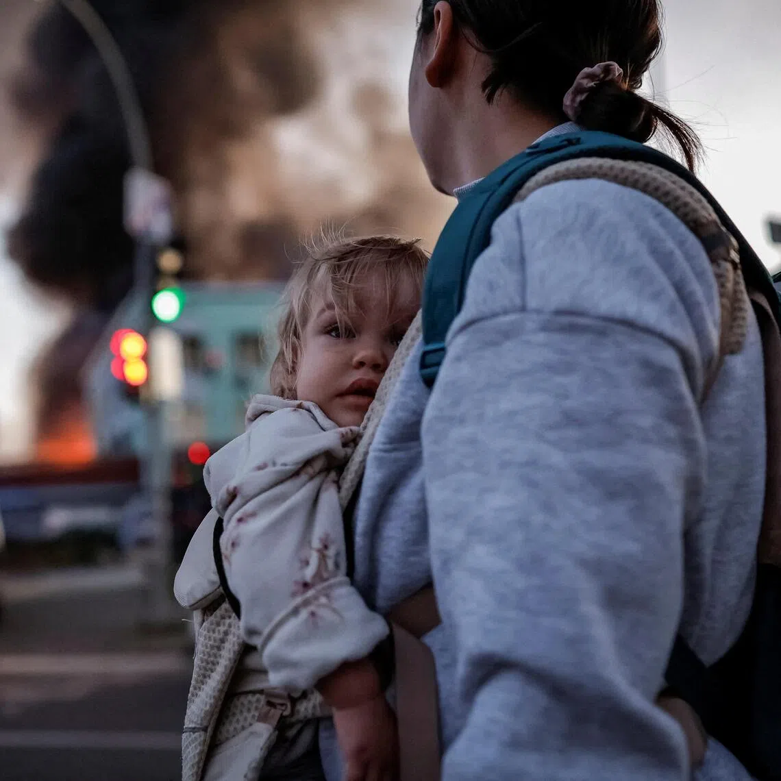 A woman and child at the site of a Russian missile strike in Kyiv, Ukraine, on Sept 8.