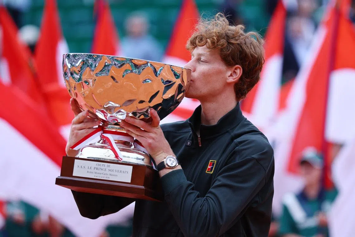 Tennis - ATP Masters 1000 - Monte Carlo Masters - Monte Carlo Country Club, Roquebrune-Cap-Martin, France - April 12, 2026 Italy's Jannik Sinner celebrates with the trophy after winning his final match against Spain's Carlos Alcaraz REUTERS/Manon Cruz