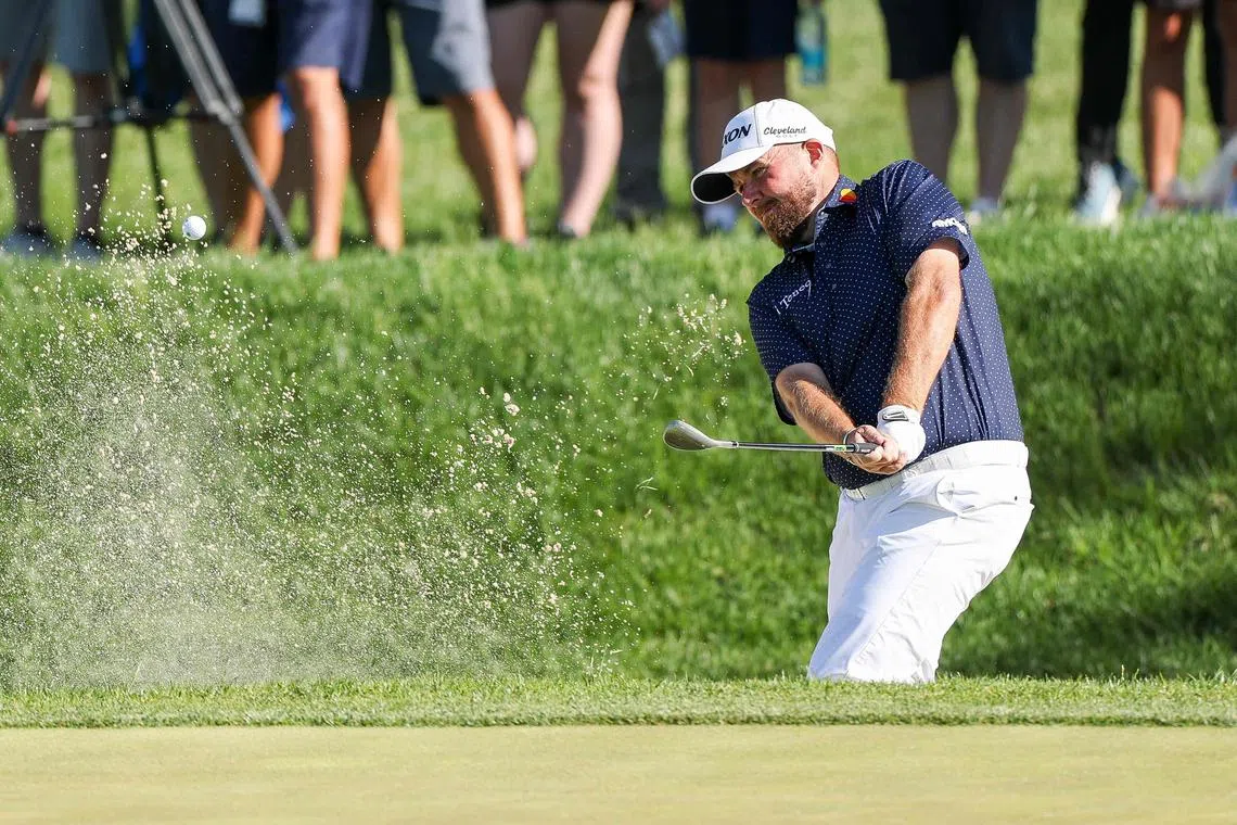 Shane Lowry of Ireland hits out of a greenside bunker on the 12th hole during the third round of the Truist Championship.