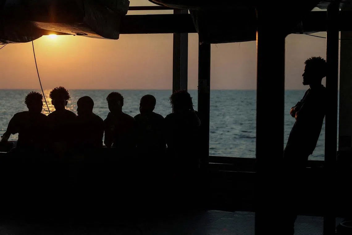 Rescued migrants resting aboard the migrant search and rescue ship Sea-Watch 5, operated by German NGO Sea-Watch, as it makes its way towards the designated port of Salerno, Italy, Aug 13, 2025. 