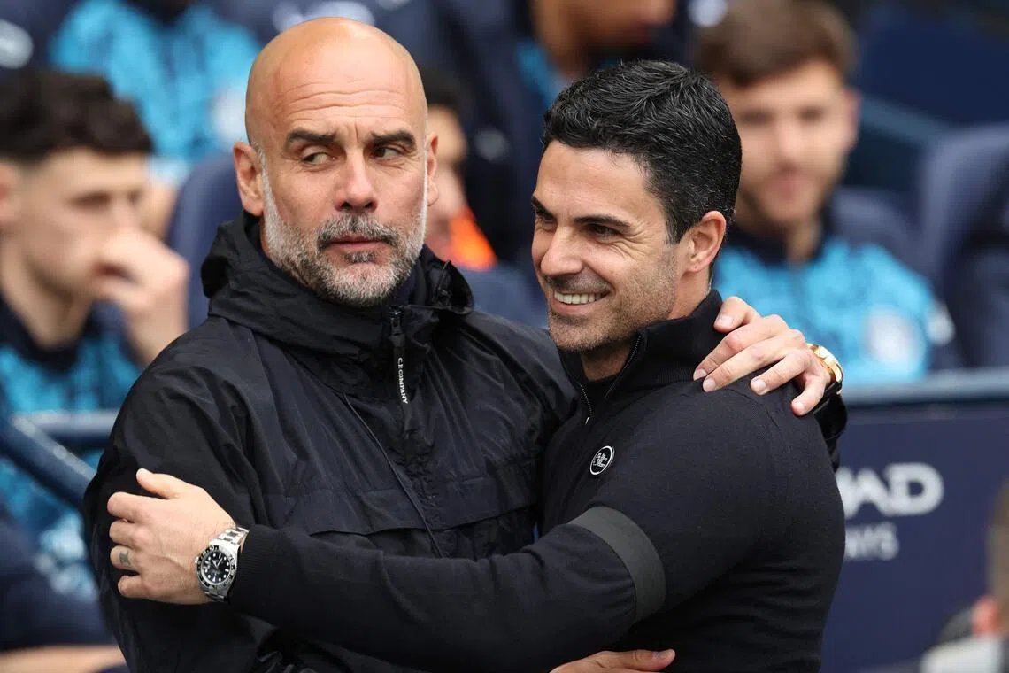 The top two teams in the Premier League this season, Arsenal and Manchester City, are coached by Spaniards Pep Guardiola (left) and Mikel Arteta.