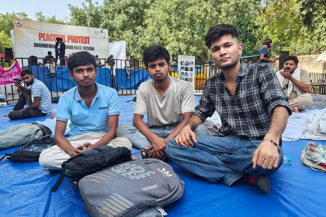 Supporters Abhijit Kumar (extreme left), a 23-year-old from the eastern Indian state of Bihar, and Happy Sahani (centre), also 23, from Uttar Pradesh, are camping out at the protest site in New Delhi. Credit: Debarshi Dasgupta