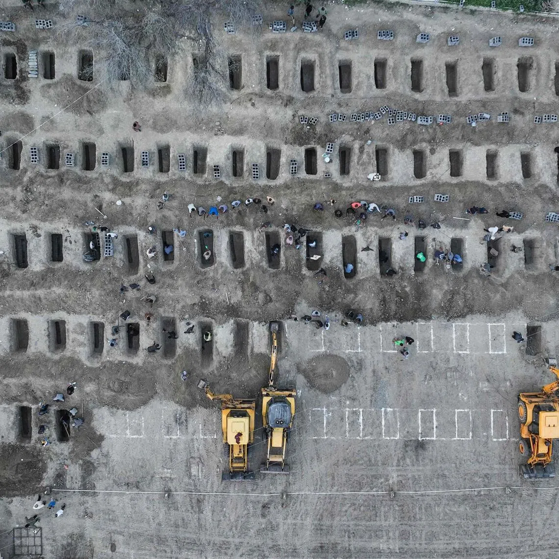 A photo released by the Iranian press centre of graves being dug on March 3 for the children killed in a reported strike on a school in the country. 