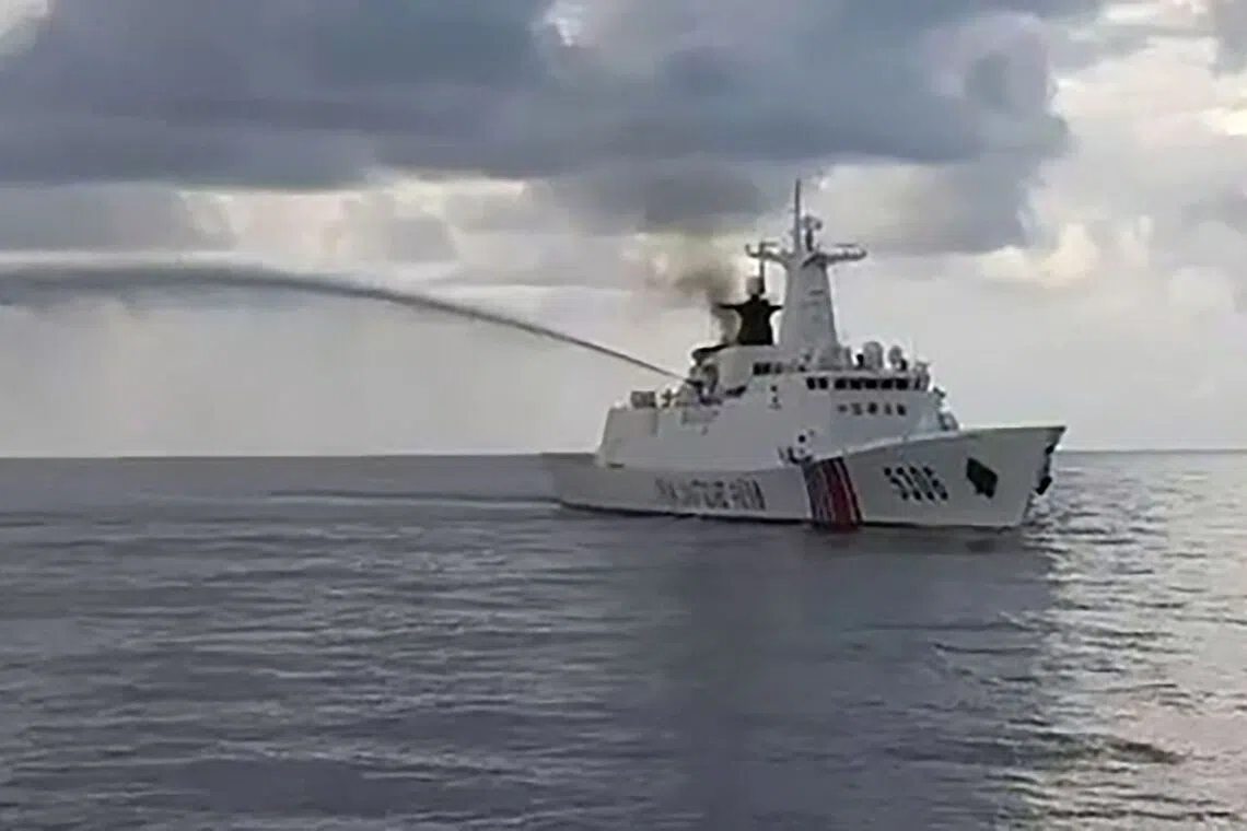 A Chinese Coast Guard ship firing its water cannon next to a Philippine Coast Guard ship during a medical evacuation in the disputed South China Sea on Oct 8.
