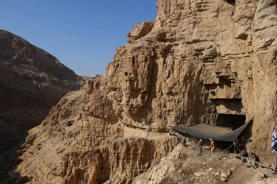 Volunteers of the Israel Antiquities Authority look for archaeological finds in the Murabba'at cave in the Judean Desert near Metzuki Dargot village, close to the Dead Sea, Israel, 28 December 2022. 