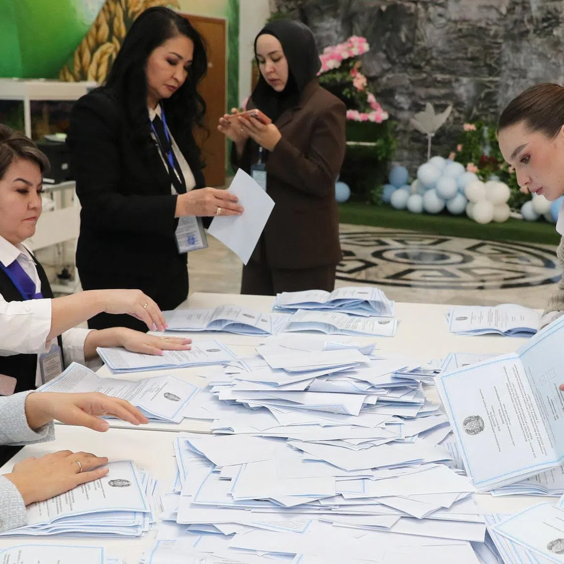 Members of a Kazakh electoral commission count votes after polling stations closed on the day of a referendum on a new constitution in Almaty, Kazakhstan, March 15, 2026. REUTERS/Pavel Mikheyev