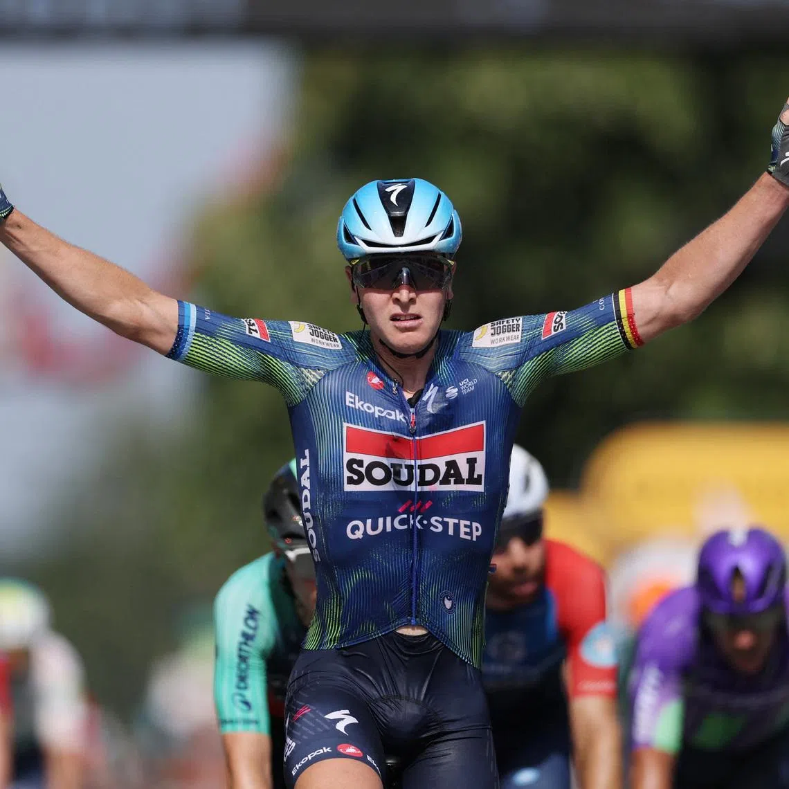 Soudal Quick-Step’s Tim Merlier celebrates after crossing the finish line to win stage 8.