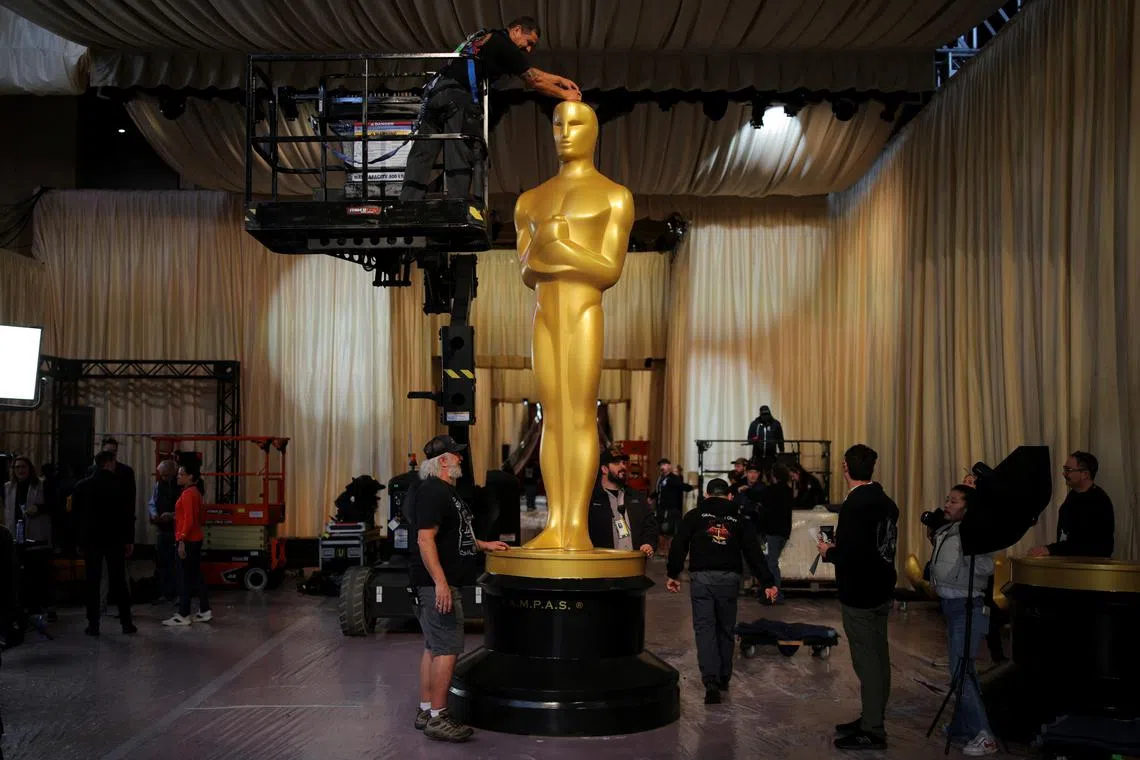 Workers assemble an Oscar statue at the arrivals area for the 97th Academy Awards, as preparation continues in Los Angeles, California, U.S. March 1, 2025. REUTERS/Daniel Cole
