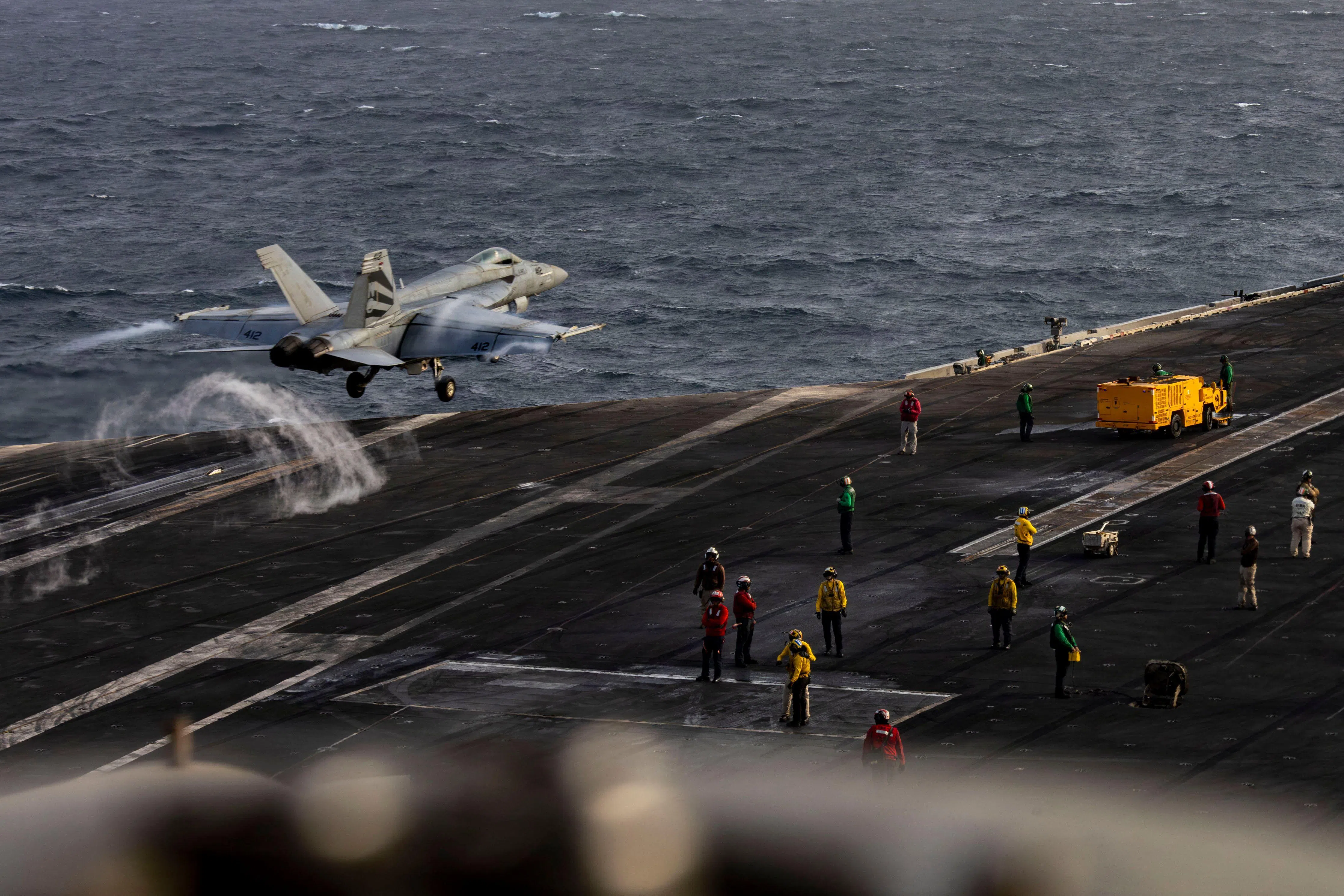 A US Navy photograph shows an F/A-18E Super Hornet launching from the flight deck of the USS Abraham Lincoln on July 31.