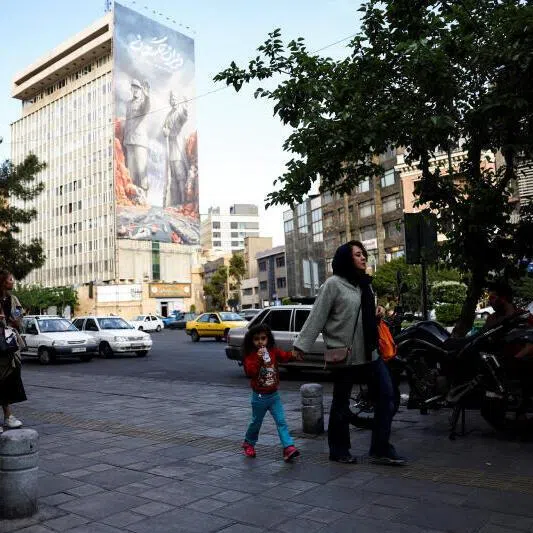 People walking past a billboard about the Strait of Hormuz, in Tehran, Iran, on May 17.