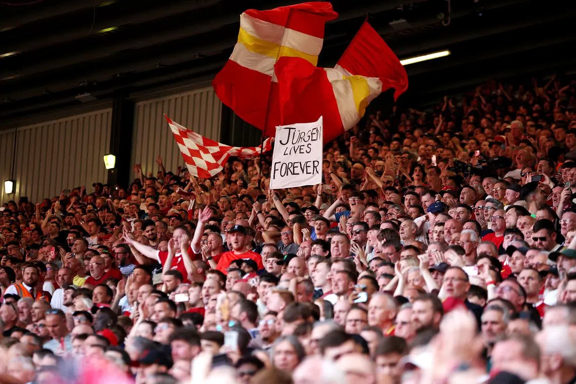Soccer Football - Premier League - Liverpool v Wolverhampton Wanderers - Anfield, Liverpool, Britain - May 19, 2024 Fan holds up a sign a message in support of Liverpool manager Juergen Klopp on his last match REUTERS/Phil Noble
