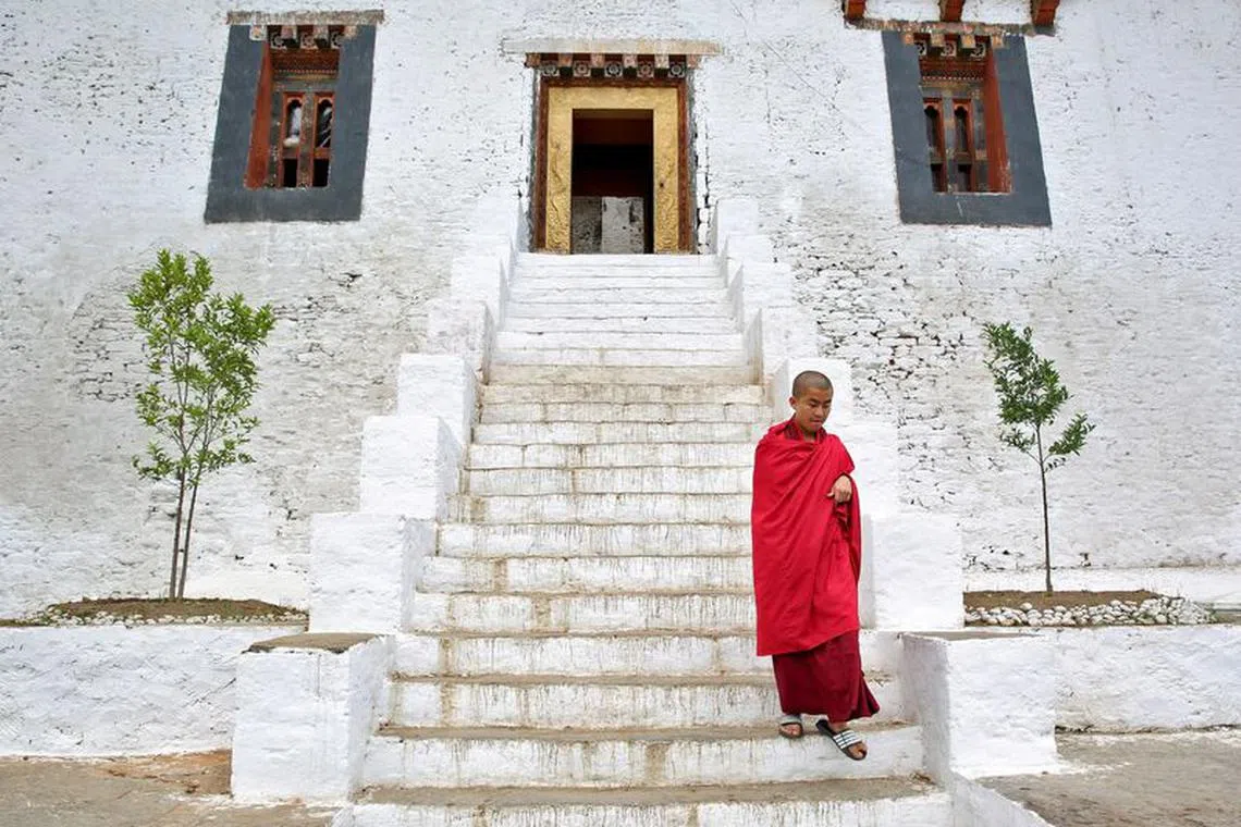 FILE PHOTO: A monks makes his way from the Punakha Dzong, Bhutan, April 17, 2016. REUTERS/Cathal McNaughton/File Photo