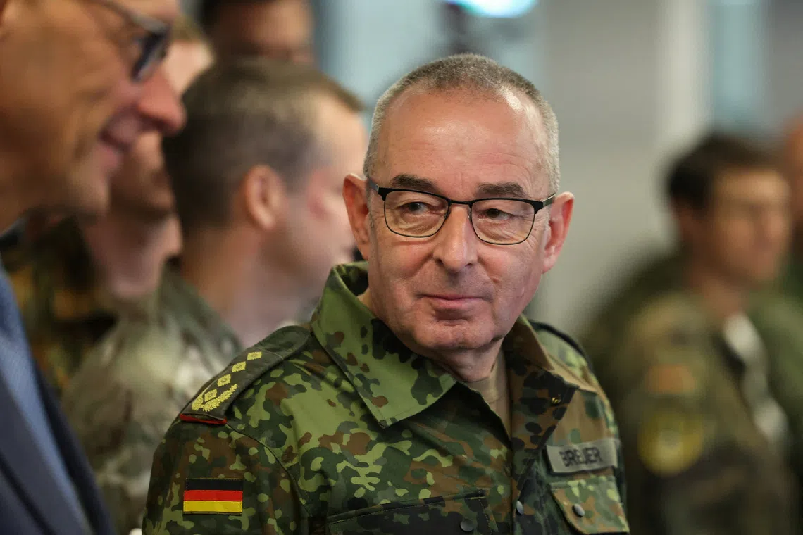 German Chancellor Friedrich Merz and Inspector General of the Bundeswehr talk as Merz visits the 1 German-Netherlands Corps (1GNC) in Muenster, Germany, October 1, 2026. REUTERS/Leon Kuegeler