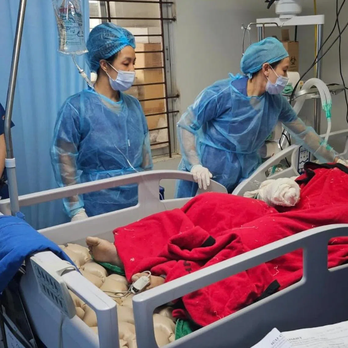 Dr Jolin Wong (left) and Dr Irene Wong from SGH's Department of Surgical Intensive Care checking on a burn patient in Dhaka.