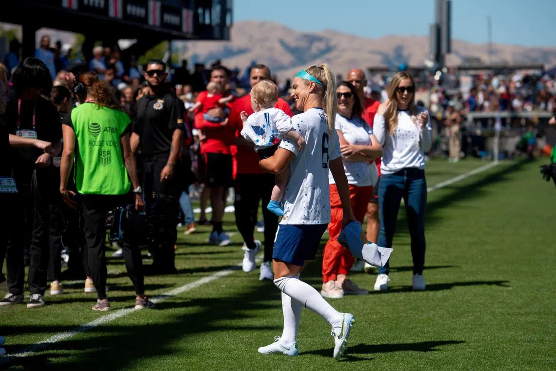 Julie Ertz holds her son Madden after a World Cup preparatory match against Wales in San Jose, California, in July.