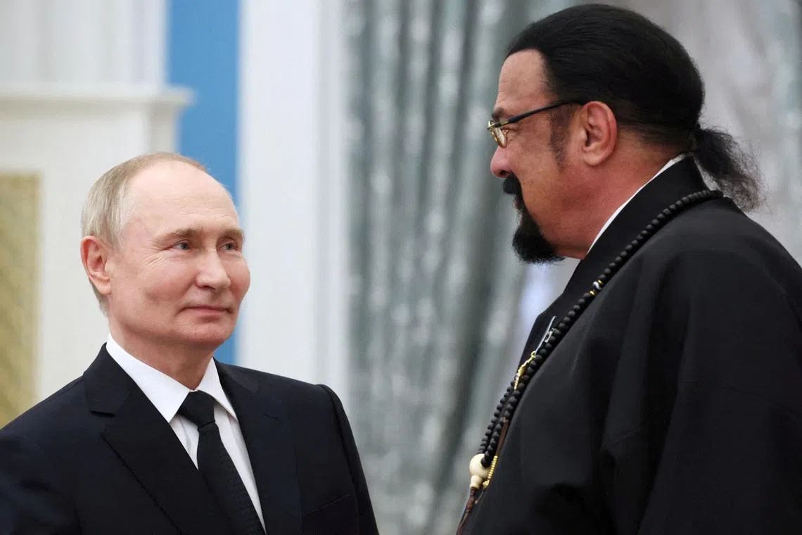 FILE PHOTO: Russian President Vladimir Putin and Russian Foreign Ministry's special representative for Russian-American humanitarian relations, actor and producer Steven Seagal, awarded with the Order of Friendship, attend a ceremony to present highest state decorations at the Kremlin's St. Catherine Hall in Moscow, Russia May 30, 2024. Sputnik/Alexander Kazakov/Pool via REUTERS/ File Photo