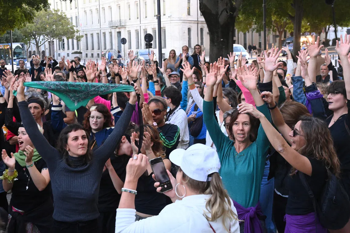 Women demonstrate outside the courthouse in support of French woman Gisele Pelicot, the victim of a mass rape orchestrated by her then-husband Dominique Pelicot.
