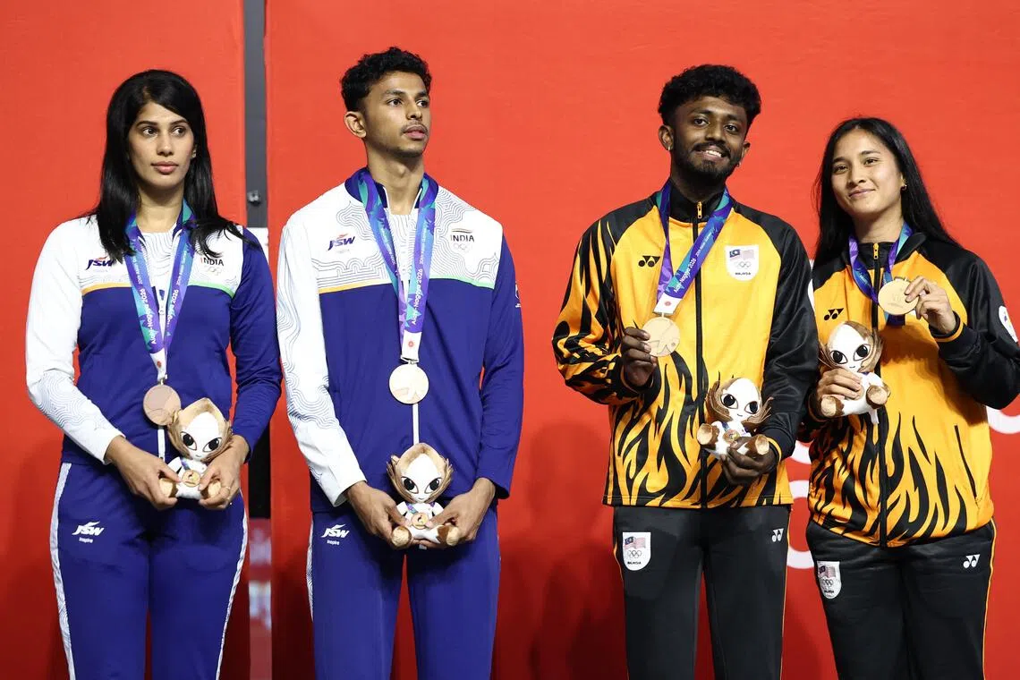 India’s Joshna Chinappa (left) and Velavan Senthilkumar on the podium with fellow Asian Games squash mixed doubles bronze medallists Ameeshenraj Chandaran and Rachel Mae Arnold of Malaysia on Sept 27.