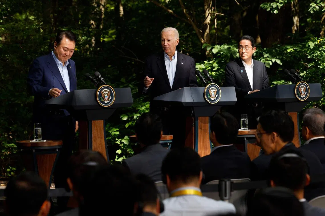 (From left) South Korean President Yoon Suk Yeol, US President Joe Biden and Japanese Prime Minister Kishida Fumio hold a joint news conference following three-way talks at Camp David.