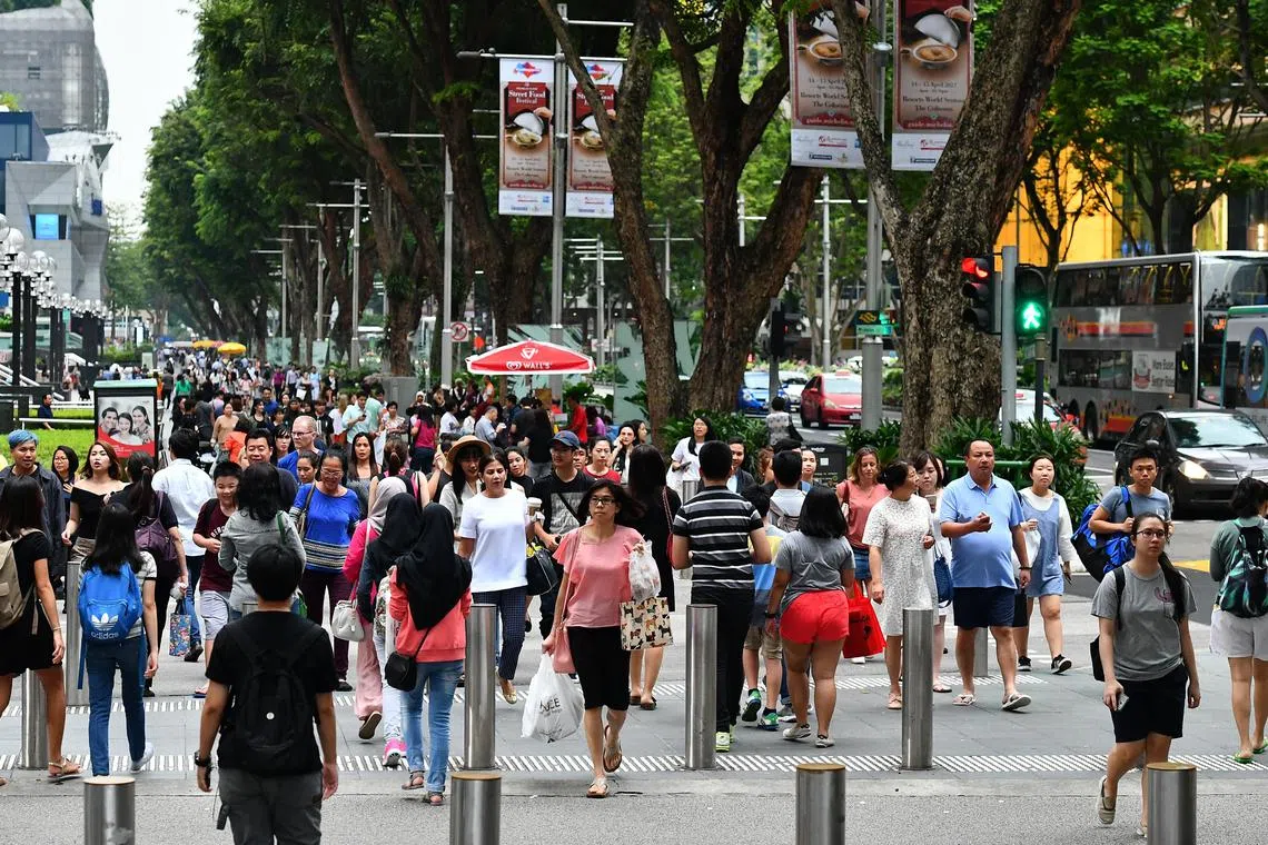 Pedestrians crossing at the junction of Orchard Link and Orchard Road on 13 April 2017.