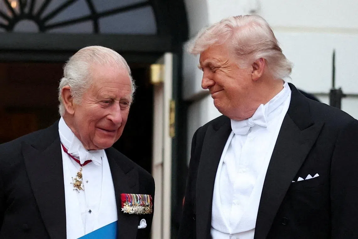 U.S. President Donald Trump smiles at Britain's King Charles ahead of a state dinner at the White House in Washington, D.C., U.S., April 28, 2026. REUTERS/Suzanne Plunkett